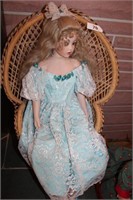 Large Doll in Wicker Chair