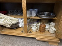 CONTENTS BOTTOM OF HUTCH -TABLE CLOTHS, BASKET,