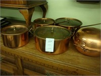 Five pieces of copper cookware.