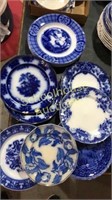 Stack of assorted plates mostly flow blue various