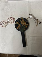 glasses lot and hand help mirror