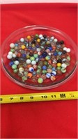 Pie dish full of marbles and shooter, dish not