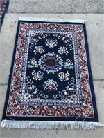 64 by 44 inch red, blue, and white rug