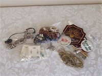Six bags of miscellaneous jewelry pins and badges