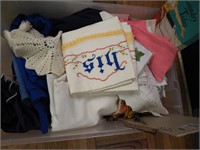 Container of linens: embroidered pillow cases,