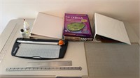 Three ring binders, paper, cutters, rulers, and