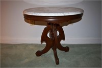 Carved walnut circular marble top stand