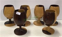 A lot of six carved wooden pedestal glasses