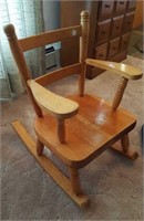 Child's wood rocking chair with blue pad