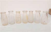 7 HALF PINT MILK BOTTLES- 3 CENT DEPOSIT-