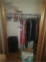 Contents of closet. Includes clothing, suitcase,