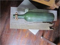 Green Bottle On Wooden Slab