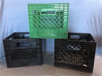 Three Plastic Milk Crates, Two Black & One Green.