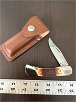 Sharp pocket knife with leather sheath