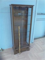 Curio cabinet with glass shelves and doors.