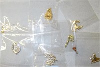 7 packages of gold charms