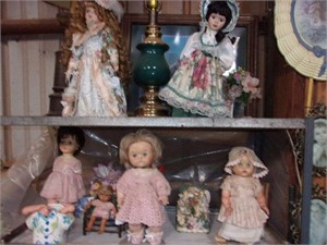 Bisque dolls, lamps, and metal rack