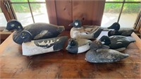 7 carved wood duck decoys, two with glass eyes,