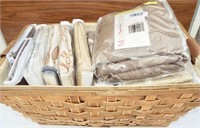 Large basket of window curtains and panels. All