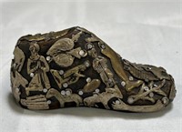 Mexican folk art milagro-covered child's shoe