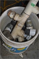 bucket of plumbing fittings