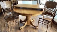 Round oak wood table and 2 pressed back chairs