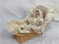 Vintage musical baby doll in basket