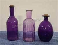 Purple bottles. Some with corks.