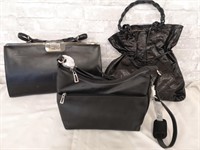 Lot of three black leather handbags.