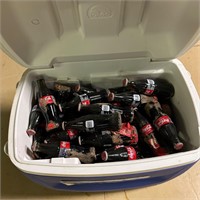Cooler Filled with Coca Cola Bottles