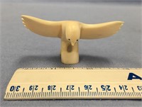 An ivory owl, with a 3" wingspan, about 1 1/4" tal
