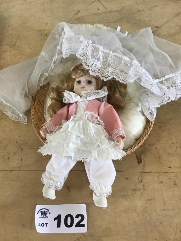 PORCELAIN DOLL IN BASKET