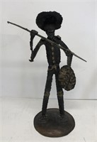 Metal sculpture of a man with spear