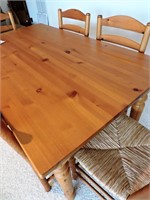 Pine wood table with 6 chairs.