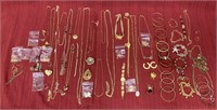 67 pieces of gold colored costume jewelry. 20