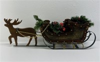 Christmas reindeer sled with decorations inside.
