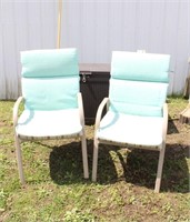 Two metal lawn chairs with removable, reversible