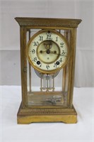 Antique French gold tone brass clock, one side