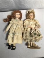 Porcelain dolls w glass eyes 12 in long