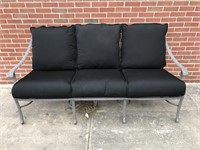 Cast aluminum sofa with cushion