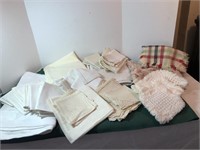 Assorted linens, mostly white