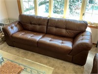 Brown leather tufted sofa
