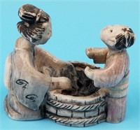 Japanese ivory netsuke of woman doing laundry