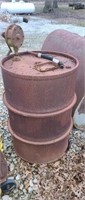 Large old steel drum with hand crank pump