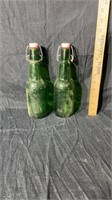 2 green glass bottles