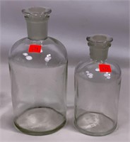 2 Pyrex bottles, ground stoppers, 7.5" & 8" tall.