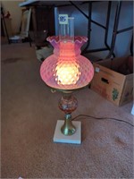 Red Fenton opalescent lamp on marblelike stand