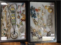 Two containers of costume jewelry including