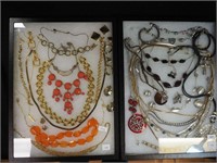 Two containers of costume jewelry including