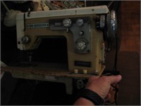 Electric Singer sewing machine in cabinet